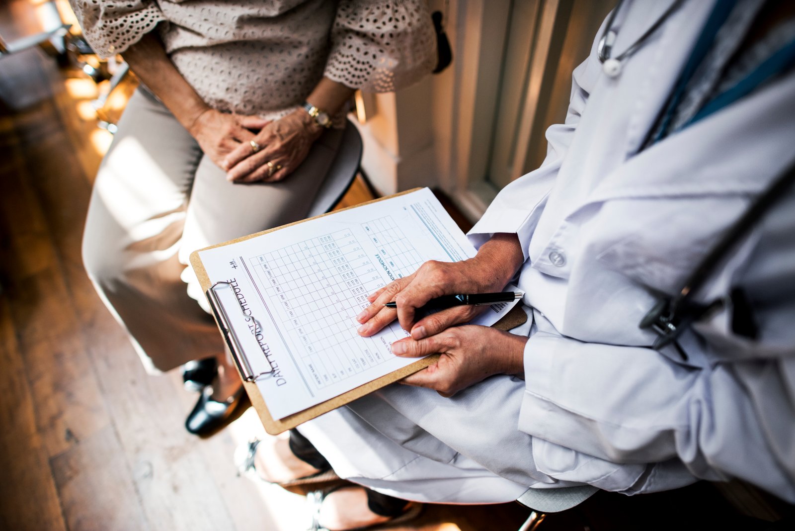 Medical office staff helping a Medicaid patient with coverage paperwork